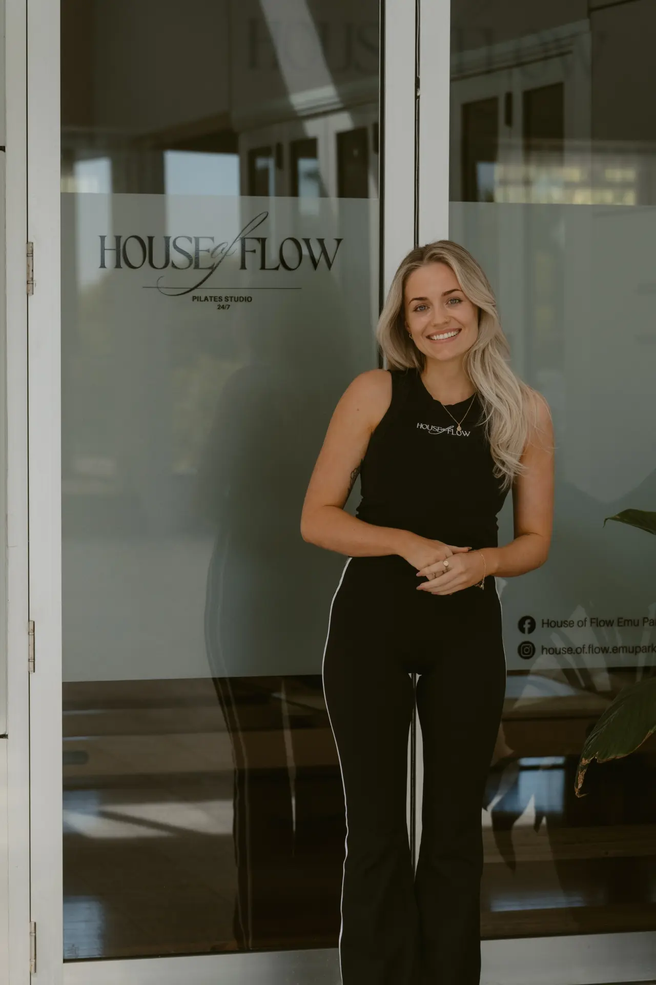 Shanae, founder of House of Flow, standing at the studio entrance